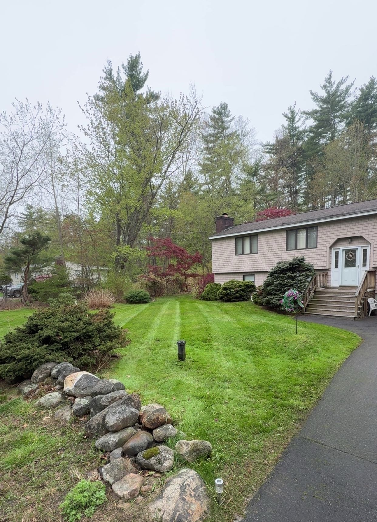 Freshly maintained lawn and landscape bed by R&A Landscaping